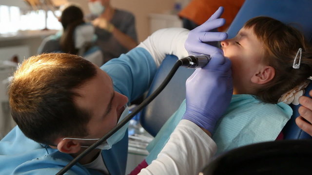 dentist treats teeth child
