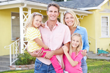 Family Standing Outside Suburban Home