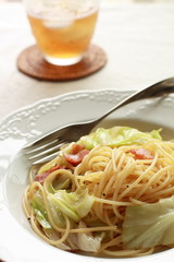 Italian cuisine, bacon and cabbage pasta with iced tea