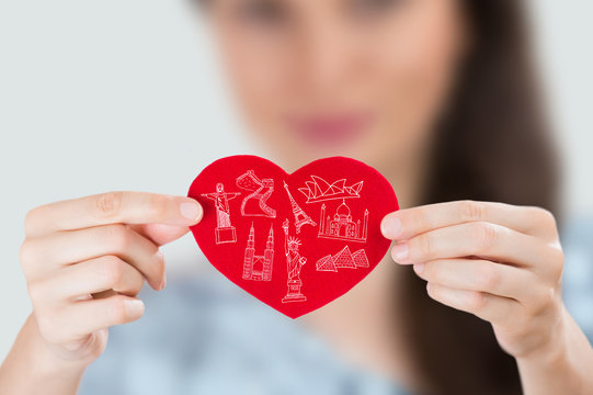 Female holding heart with her arms and famous touristic symbols