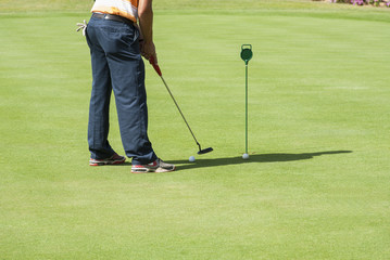 Fototapeta premium Golfer practising putting