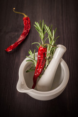 Rosemary and red hot chili pepper in a mortar