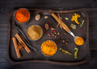 Spices and herbs in a wooden vintage tray