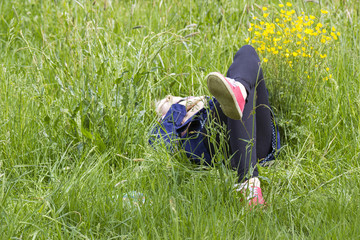 little girl lying on grass