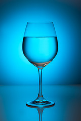 Glass with water on a blue background