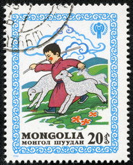 stamp printed by Mongolia, shows Boy Running with Lambs