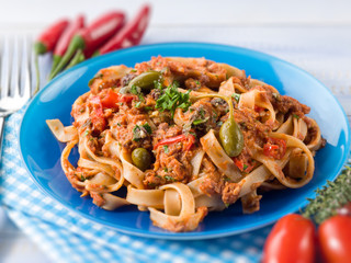 tagliatelle with tuna tomatoes and capers, selective focus