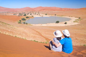 Travelers in Africa, couple on romantic vacation in Namibia