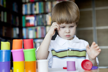 Little boy creating toys from playdough