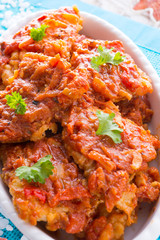 fish in Greek kind with vegetables and tomato sauce