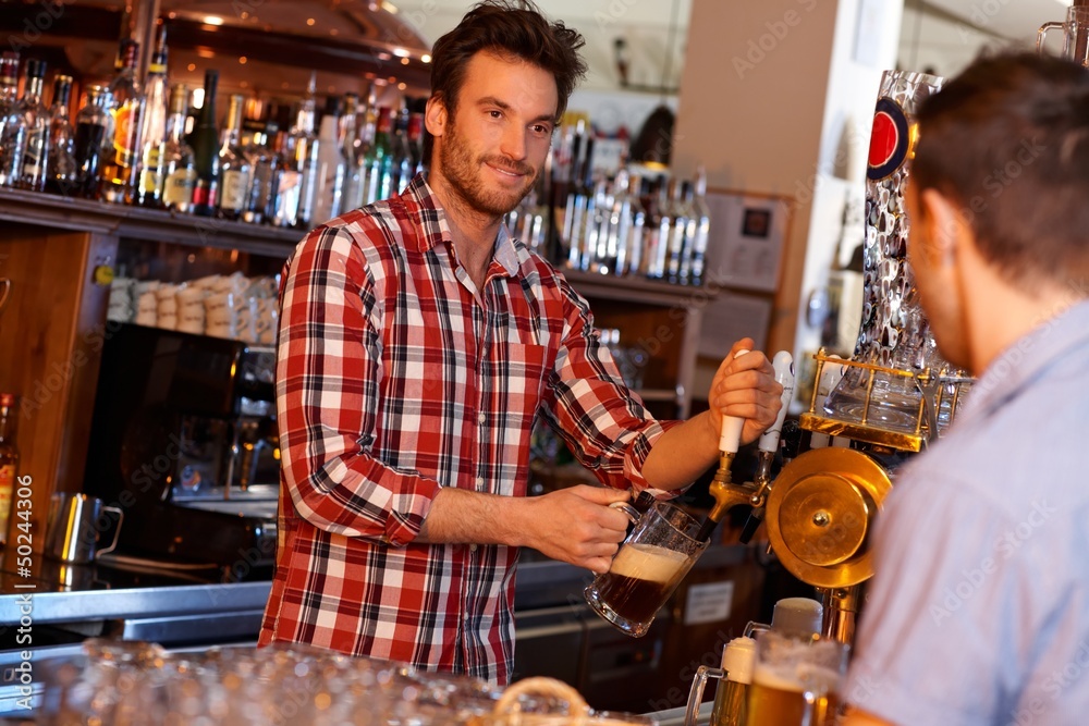 Sticker bartender serving draught beer in bar