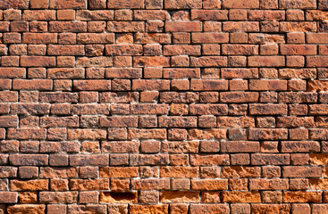Old weathered red brick wall as background