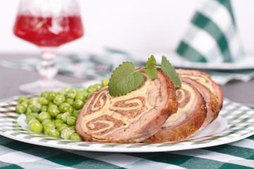 Obraz na płótnie Canvas Meat stuffed with cheese, garnished with green peas