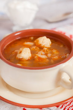 Soup with beans and dumplings in soup bowl