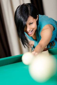 Woman playing billiards