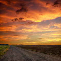 Road in meadows and beautiful sunset