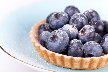 blueberries tart on the blue plate