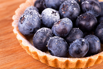 blueberries tart on the wooden board