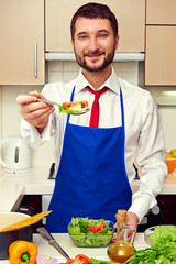 handsome man offering fresh salad