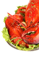 Red lobster on platter with vegetables isolated on white