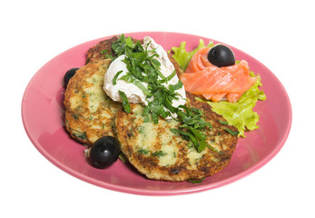 Roasted cutlets of potato with salmon on a plate