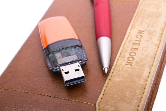 USB Flash Drive, pen and notebook