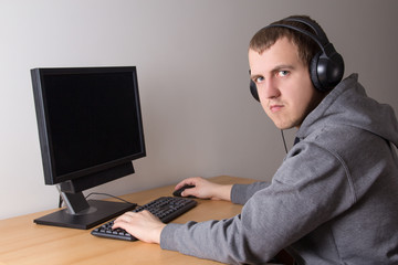 young man playing a video game on pc