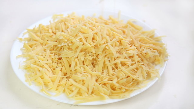 Falling pieces of grated cheese for pizza