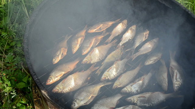 closeup ecologic fish smoked in smokehouse and smoke rise