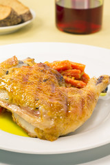 Roasted chicken with vegetables on a white plate