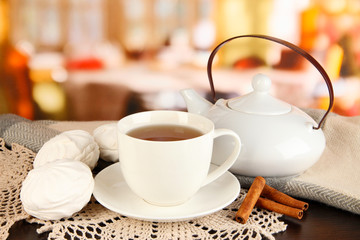 cup of tea with scarf on table in room