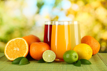 Glasses of juise with leafs and fruits