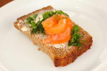 Salmon sandwich on plate, close up