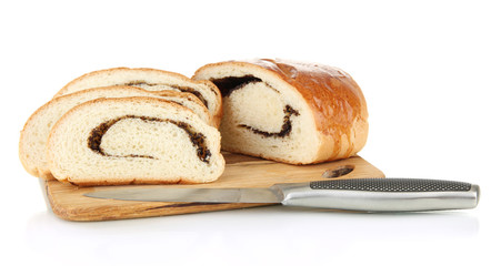 Loaf with poppy seeds on cutting board, isolated on white
