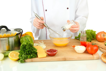 Female hands blending eggs in glass bowl