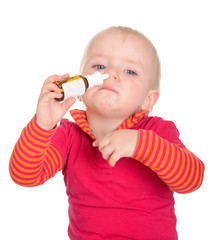Little baby girl spraying herself nose spray isolated on white b