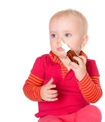Little baby girl spraying herself nose spray isolated on white b
