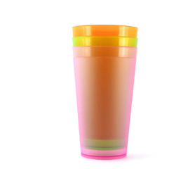 Green, orange and pink cups over white