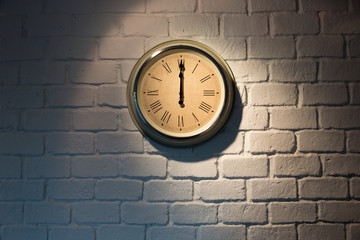 Vintage clock on a white brick wall