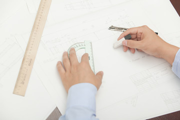 Hands male architect to make drawings using pencil and compass