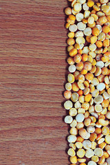 Splitted dried peas on the wooden background