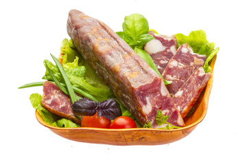 Ripe salami with salad, basil, onion and tomato