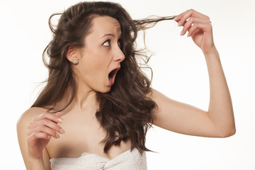 shocked girl because of her damaged hair