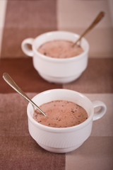 Two mugs with hot chocolate.