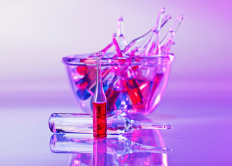 Medical ampoules still life in vivid violet colors