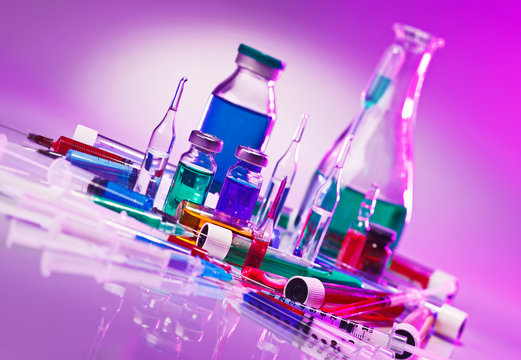 Medical laboratory glass equipment still life on blue purple