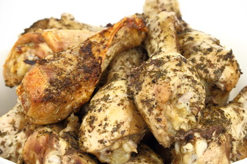 Roasted chicken legs in the white dish