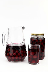 Compote with cherries in jar, glass and ewer