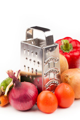 vegetables and grater isolated on white