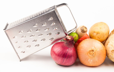 vegetables and grater isolated on white